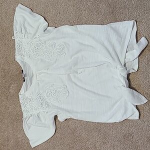 Tie front shirt with lace accent.